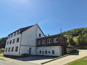 a large white building with a brown at Bergwiesnblick Apartments in Bärenstein