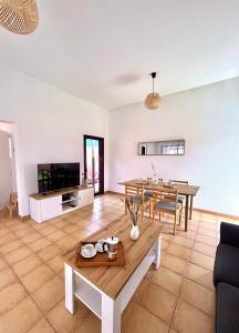 a living room with a table and a dining room at Tajora House by Best Holidays Fuerteventura in La Oliva