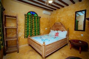 a bedroom with a large bed in a room at Peace House Zanzibar in Bwejuu