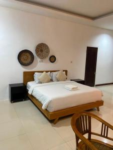 a bedroom with a large bed in a room at casavina studio 304 private kitchen, Near beach in Canggu +40 photos