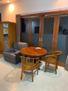a living room with a wooden table and two chairs at casavina studio 304 private kitchen, Near beach in Canggu
