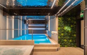 a hot tub in a room with a green wall at INCOGNITO Basen & SPA widok na góry in Białka Tatrzańska