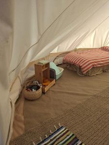 a bedroom with a tent with a bed and a bed sqor at Luxury Glamping - Heydaze in Lostwithiel