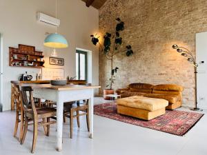 a kitchen and living room with a table and a couch at Bricco Aivè in Costigliole dʼAsti