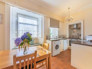 a kitchen and dining room with a table and chairs at The Garden Apartment - Uk48320 in Berwick-Upon-Tweed