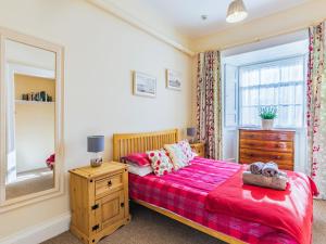 a bedroom with a bed and a dresser and a mirror at The Garden Apartment - Uk48320 in Berwick-Upon-Tweed +13 photos