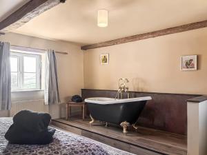 a bathroom with a bath tub in a room at Holme House in Halton Gill