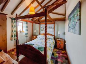 a bedroom with a canopy bed in a room at Gull Newk in Flamborough