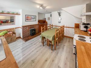 a kitchen and dining room with a table and chairs at 10 The Apostles - Uk37312 in Lochranza