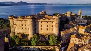 an aerial view of a castle on the water at Appartamento la casa di Mary Anguillara Sabazia-Lago,Relax e Roma a portata di treno in Anguillara Sabazia
