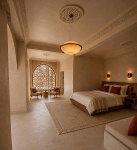 a bedroom with a large bed and a large window at TIZI Aït Ben Haddou in Aït Benhaddou