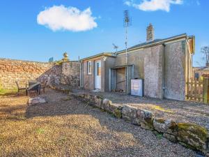 a house with a stone wall next to a building at South Lodge - Uk48318 in Berwick-Upon-Tweed +14 photos