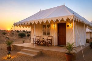 a tent with a table and chairs in the desert at Oran Desert camp & Resort in Sām +7 photos