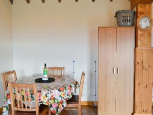 a dining room table with a bottle of wine on it at Meadow Cottage - Uk45882 in Flamborough