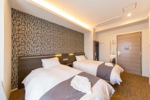 Voodi või voodid majutusasutuse Hotel M's Plus Shijo Omiya toas
