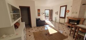 a living room with a couch and a fireplace at HOLIDAY HOUSE LE COCCINELLE in Salò