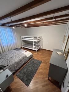 a bedroom with a bed and a desk in it at HOLIDAY HOUSE LE COCCINELLE in Salò