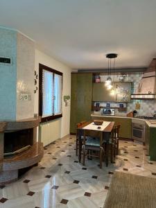 a kitchen with a table and chairs in a room at HOLIDAY HOUSE LE COCCINELLE in Salò