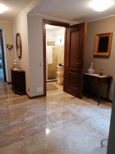 an empty living room with a door and a hallway at HOLIDAY HOUSE LE COCCINELLE in Salò +20 photos