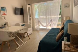 a room with a bed and a table and a dining room at Flat With Swimming Pool Close To The Beach in Arcachon