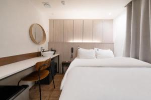 a hotel room with a bed and a sink at Just Stay Hotel in Seoul