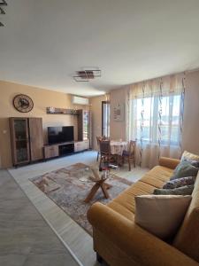 a living room with a couch and a table at Kalina Family Hotel in Burgas