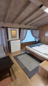 a large bedroom with a large bed and a table at Locanda Villa d' Epoca in Aurigeno