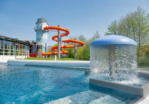 a water slide in front of a water park at Villa Vivien, Ostsee Findling App 4 - Bade- & Saunawelt täglich inklusive in Göhren