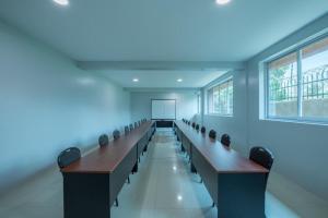 a large room with rows of desks and a white screen at KRM Hotel - Caran in Kampala