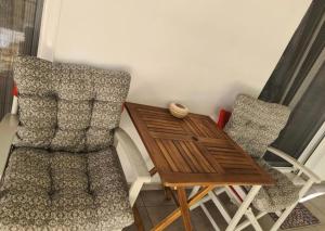 a small table and two chairs next to a small table and chairs at Loutraki by the sea in Loutraki