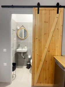 a bathroom with a wooden door with a sink at LA COSTA DI SAN GIORGIO in Agios Georgios +19 photos