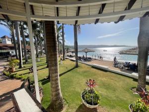 a view of a beach with palm trees and the water at Discovery Bay Villa and Beach Club in Discovery Bay