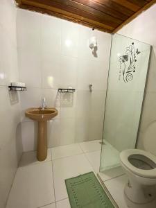a bathroom with a shower and a toilet and a sink at Pico das Praias Suites in Itacaré +14 photos