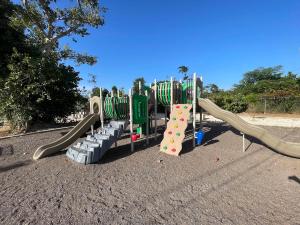 a park with a playground with slides at Discovery Bay Villa and Beach Club in Discovery Bay
