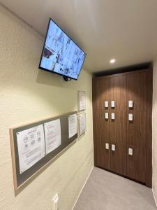 a flat screen tv on the wall of a hospital room at 303 Stayonyou Gocheok Dome Hongdae Subway 3Min in Gwangmyeong