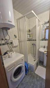 a bathroom with a washing machine and a shower at Sun Apartment in Petrovac na Moru +15 photos