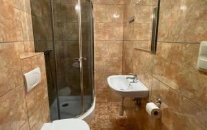 a bathroom with a shower and a sink and a toilet at Marcello Mielno in Mielno