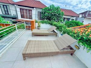 a patio with two chairs and a table at Villa Leyan 1 Semer - Between Seminyak & Canggu in Seminyak