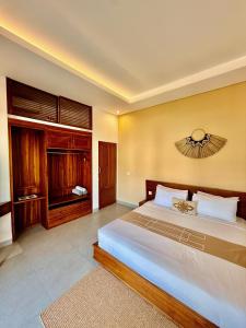 a bedroom with a large bed and a television at Villa Leyan 1 Semer - Between Seminyak & Canggu in Seminyak +11 photos