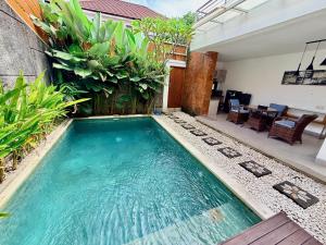 a swimming pool in the middle of a house at Villa Leyan 1 Semer - Between Seminyak & Canggu in Seminyak