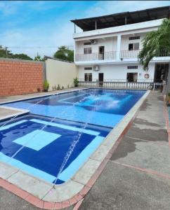 a large swimming pool in front of a building at Hotel Montanar HOME in La Dorada