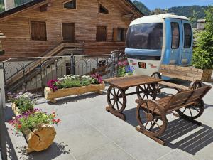 a van parked next to a bench and some flowers at Residence Stella Alpina in Santa Cristina Gherdëina