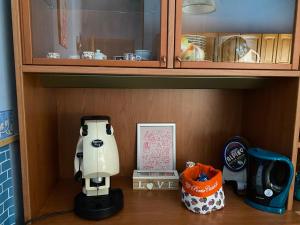 a cupboard with a hello kitty toy on a shelf at Appartamento Nonna Ida in Montesarchio