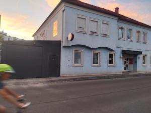 a person riding a bike in front of a building at Apartment 2 in Golling an der Erlauf in Petzenkirchen
