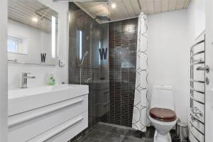 a bathroom with a shower and a toilet and a sink at 12231-Sjaellands-Odde-Rogerivej-2 in Havnebyen +15 photos