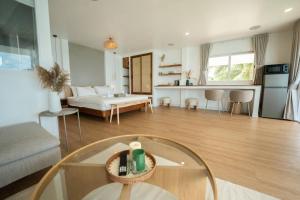 a living room with a couch and a table at Beach Terrace Studio - WaveSide Ocean Bliss in Thong Sala