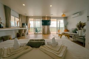 a living room with a bed with two towels on it at Beach Terrace Studio - WaveSide Ocean Bliss in Thong Sala +94 photos