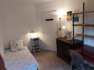 a bedroom with a bed and a dresser and a mirror at Vallon des auffes - proche mer in Marseille