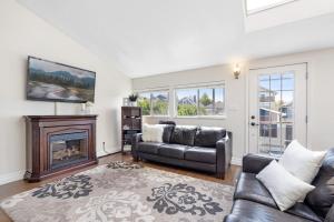 a living room with a couch and a fireplace at Family-Friendly 3BR Home in Vancouver