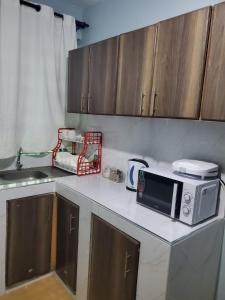 a kitchen with a microwave on a counter at Star Villas Nyahururu in Nyahururu